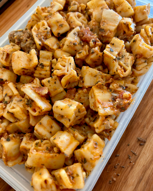 Close up of cooked handshaped pasta in tomato meat sauce in container using 16 oz 1-3-5 American Sign Language Handshaped Pasta.
