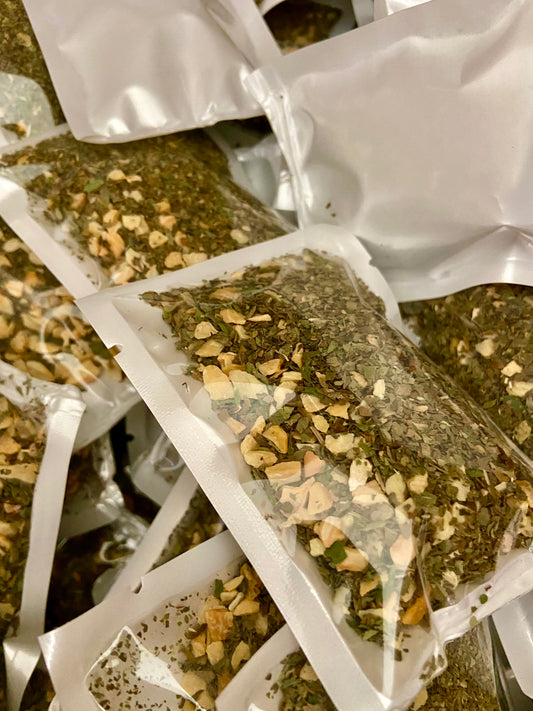 Basil pesto seasoning with dried garlic mix in clear resealable packaging from Parents Gone Hiatus