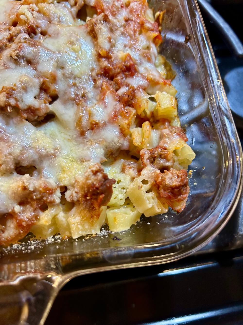 Glass baking dish of cheesy meat pasta casserole made with 16 oz 1-3-5 American Sign Language Handshaped Pasta