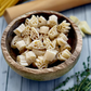Wooden bowl of uncooked handshaped pasta next to rolling pin and herbs 16 oz 1-3-5 American Sign Language Handshaped Pasta.
