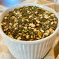 Parents Gone Hiatus basil pesto seasoning with dried garlic mix in white ceramic bowl on cloth